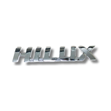EMBLEMA INYECTADO TOYOTA HILUX REVO ADHESIVO CROMADO