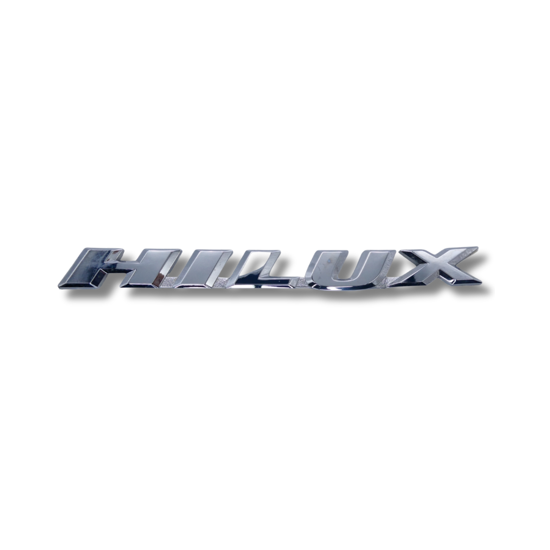 EMBLEMA INYECTADO TOYOTA HILUX HI RAIDER CROMADO INCLINADO